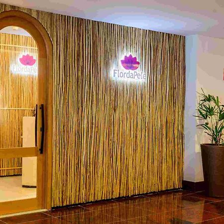 Hotel Luzeiros Sao Luis Extérieur photo The photo shows the entrance to a spa or wellness center named "FlordaPel." The wall is decorated with natural-looking materials, resembling bamboo or reeds, giving it an organic feel. A soft-lit sign with the logo is placed above the entrance, and t
