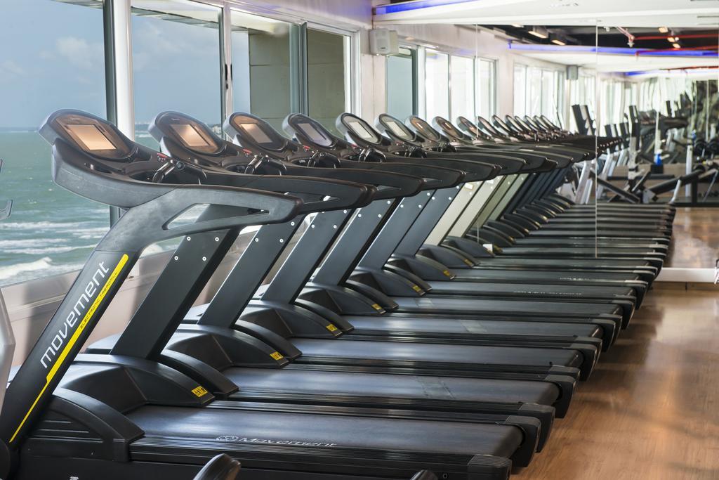 Hotel Luzeiros Sao Luis Extérieur photo The image shows a row of modern treadmills arranged in a gym or fitness center. The treadmills feature sleek designs and display screens, and they are positioned near large windows that allow natural light to enter the space. The view outside appears